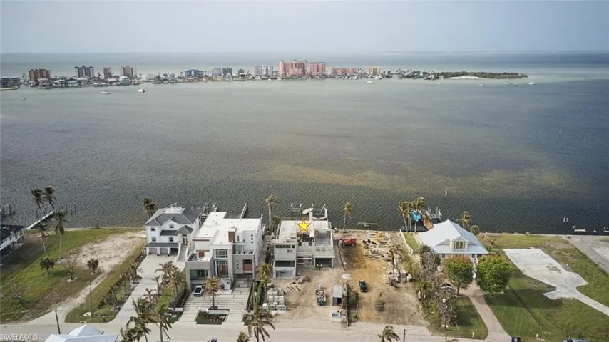 Aerial overview of property's location with a large body of water