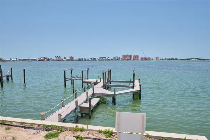 Dock area featuring a water view and a view of skyline
