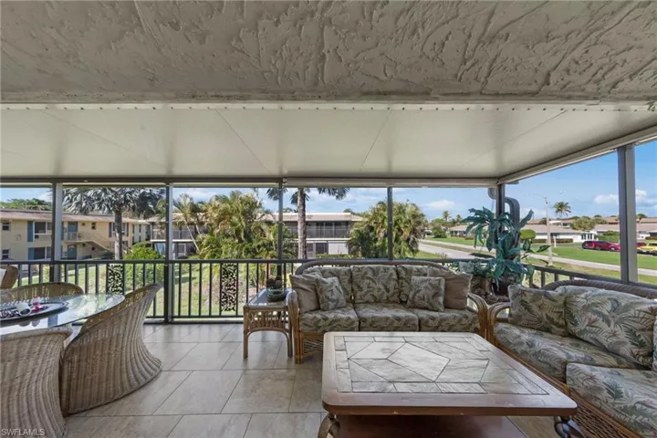 Sunroom / solarium with a residential view and tile patterned flooring