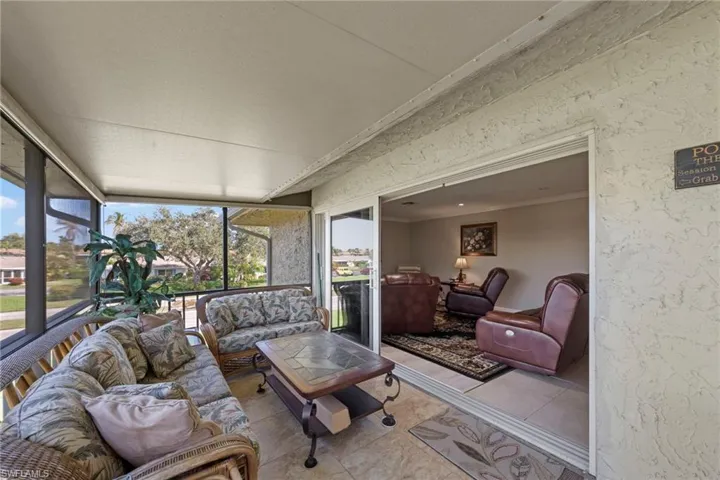 Sunroom / solarium with tile patterned floors and ornamental molding