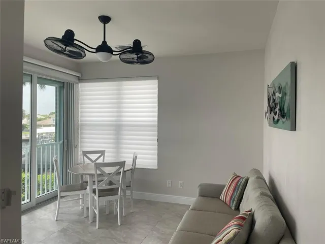 Second level loft featuring neutral wall paint, tile flooring, and a modern ceiling fan with integrated lighting