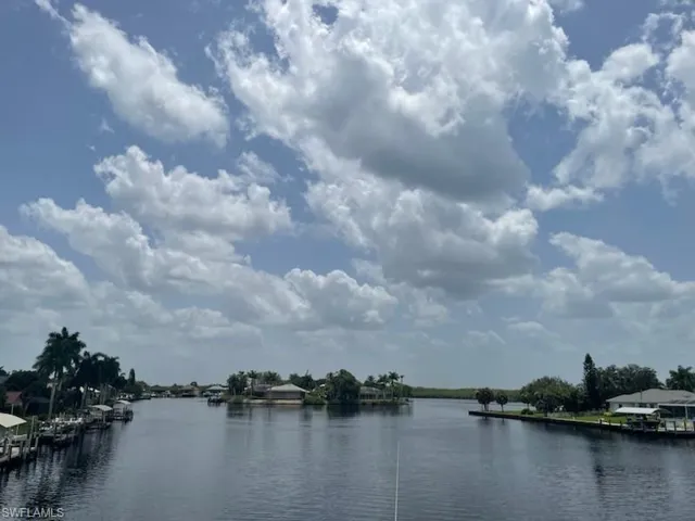 Waterfront setting featuring a wide canal and multiple boat docks