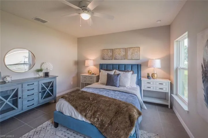 Bedroom featuring tile patterned flooring and ceiling fan