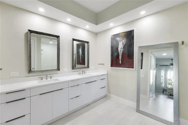Bathroom featuring double vanity, recessed lighting, and a ceiling fan