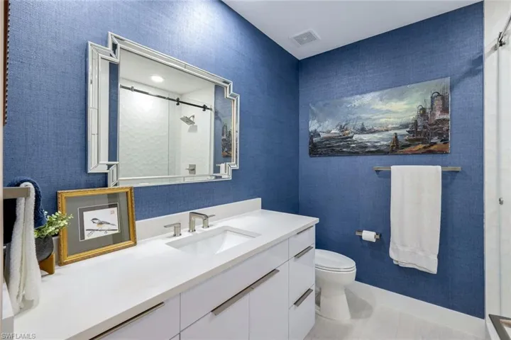 Bathroom with a shower stall and vanity