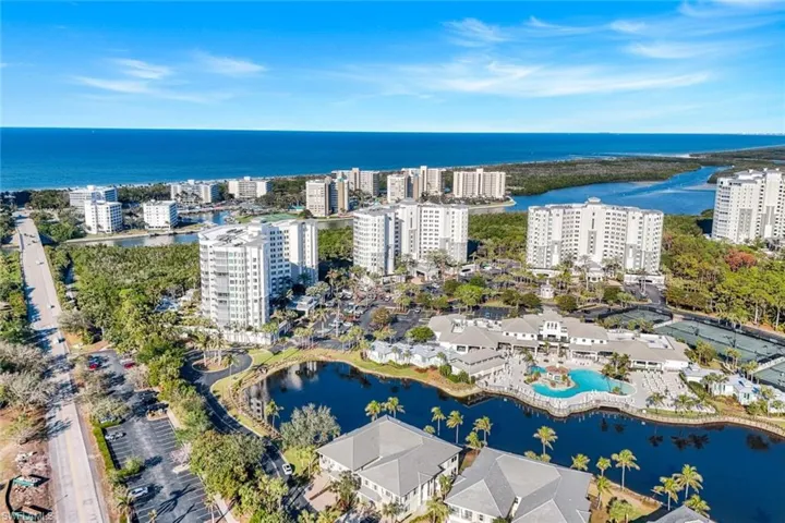 Aerial view of property and surrounding area featuring a nearby body of water and nearby urban area