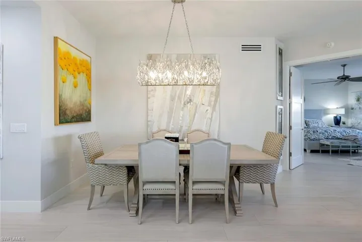 Dining space with a chandelier and ceiling fan