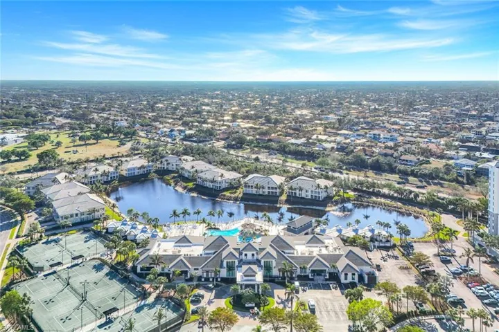 Aerial overview of property's location featuring a nearby body of water and nearby suburban area