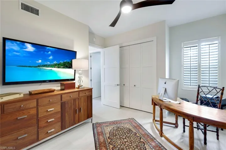 Office space with ceiling fan and light wood-style flooring