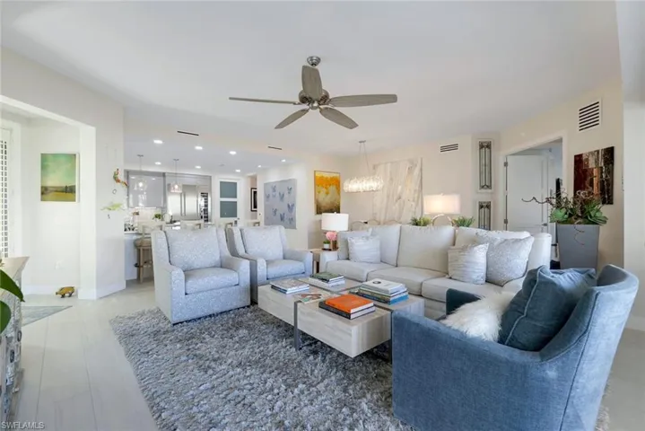 Living room with ceiling fan, a chandelier, and recessed lighting