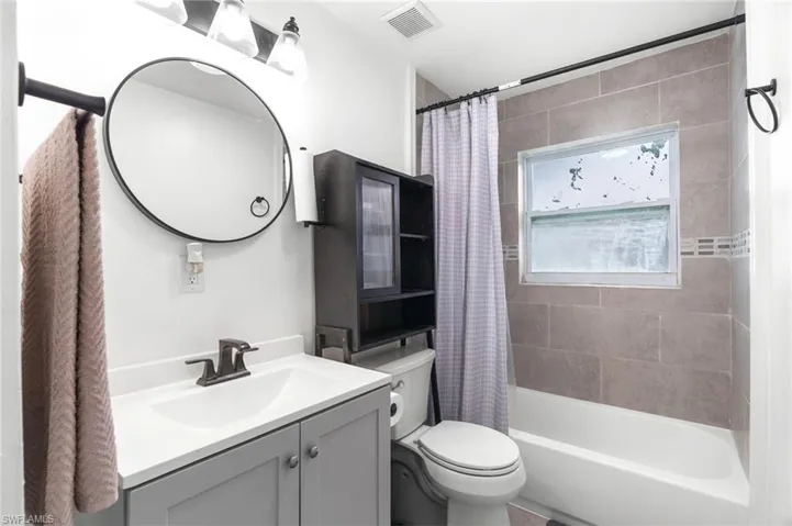 Full bath with vanity and shower / bathtub combination with curtain