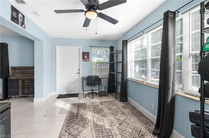 Office space featuring light tile patterned floors and ceiling fan