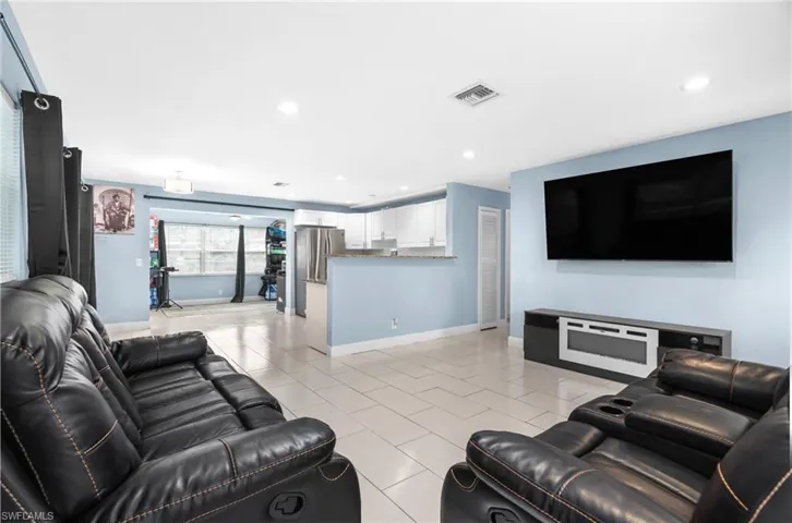 Living room featuring recessed lighting and light tile patterned floors