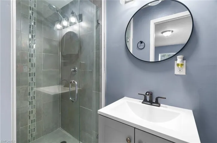 Bathroom with vanity and a stall shower