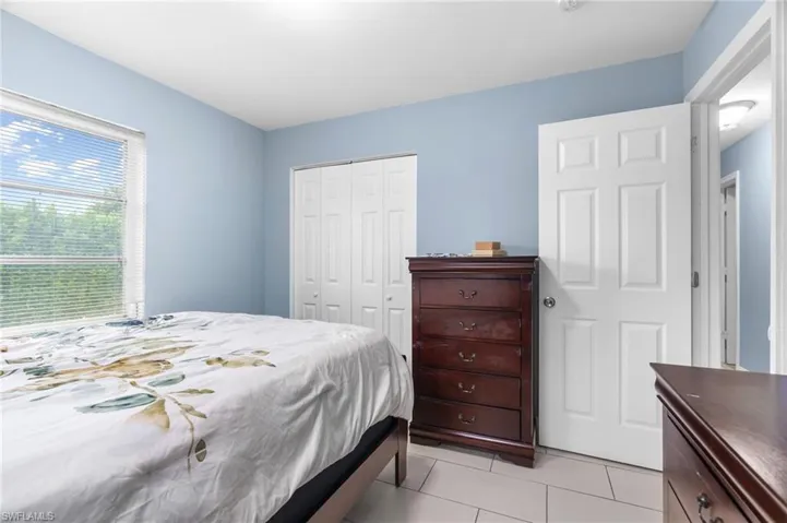 Bedroom featuring a closet and light tile patterned flooring