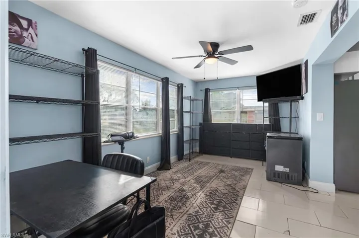 Office area featuring a ceiling fan, healthy amount of natural light, and light tile patterned floors