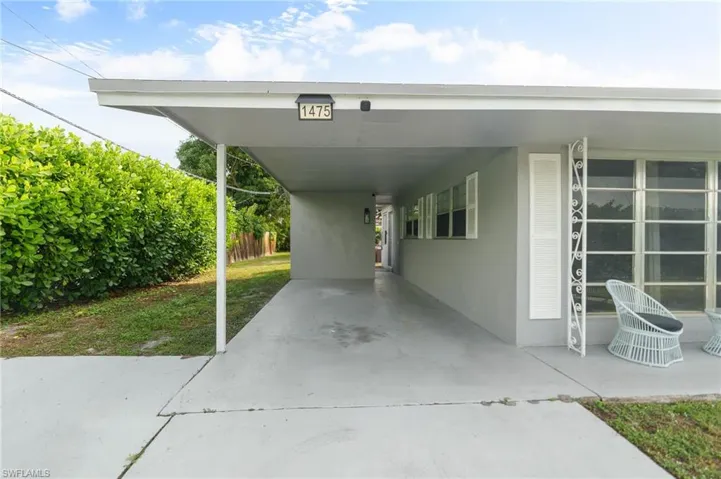 View of parking featuring a carport and concrete driveway