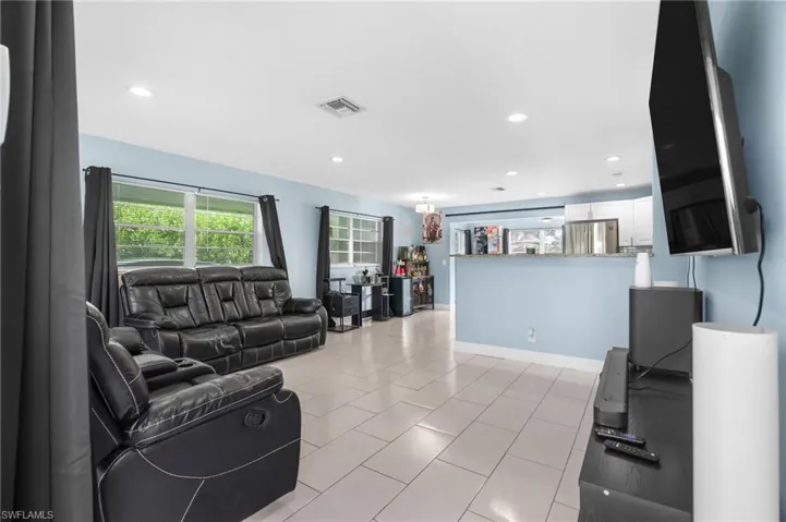 Living room featuring plenty of natural light, recessed lighting, and light tile patterned floors