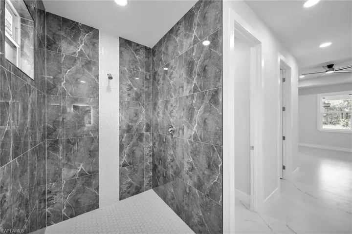 Full bathroom with recessed lighting, a walk in shower, marble finish floor, a ceiling fan, and baseboards