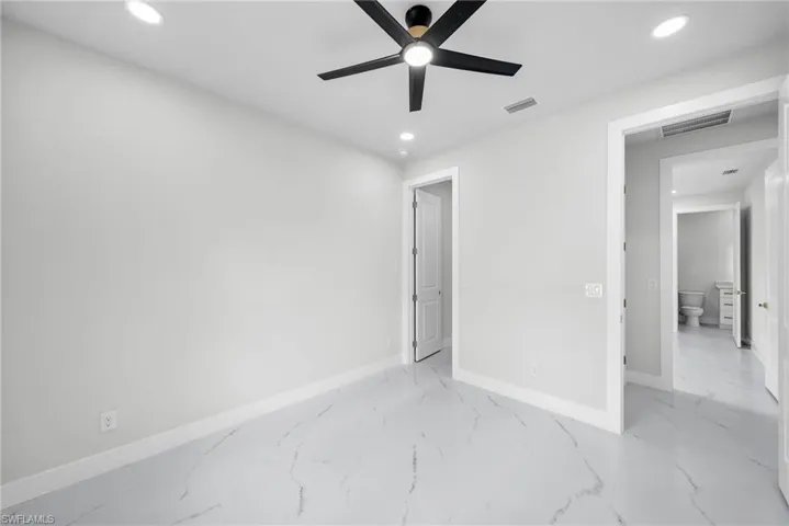 Unfurnished bedroom with recessed lighting, marble finish floor, visible vents, and baseboards