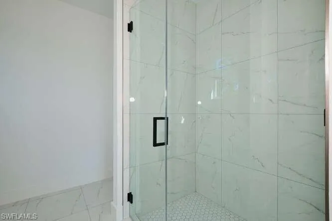 Bathroom with a marble finish shower