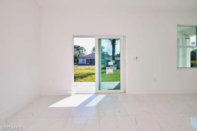 Spare room with plenty of natural light and light marble finish flooring