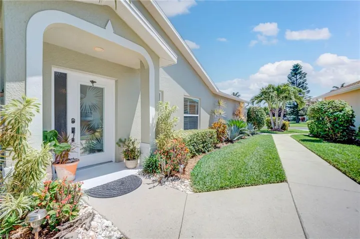 Private entrance on the side of the hom with palms and landscaping that is new!