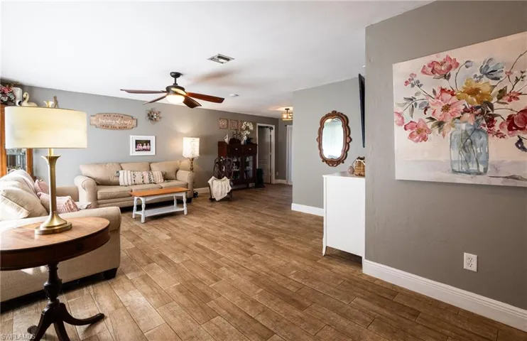 Living room featuring ceiling fan and wood-type flooring