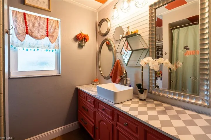 Bathroom featuring ornamental molding and vanity