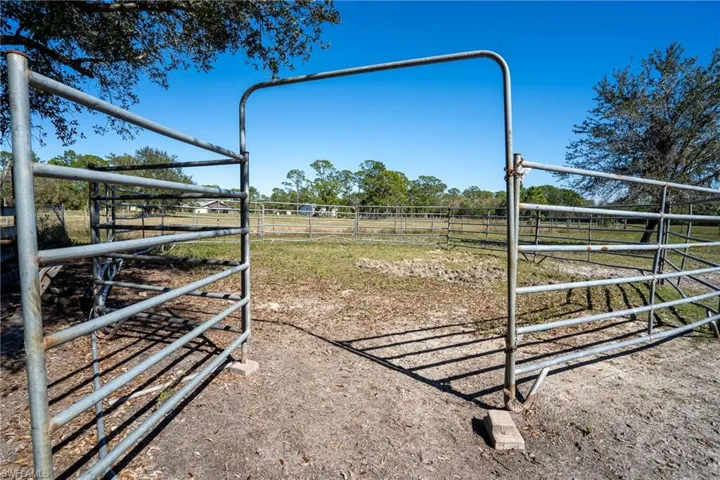 View of yard with a rural view and an outdoor structure