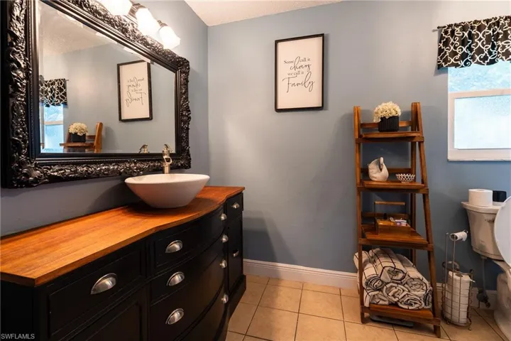 Bathroom featuring tile patterned flooring and vanity