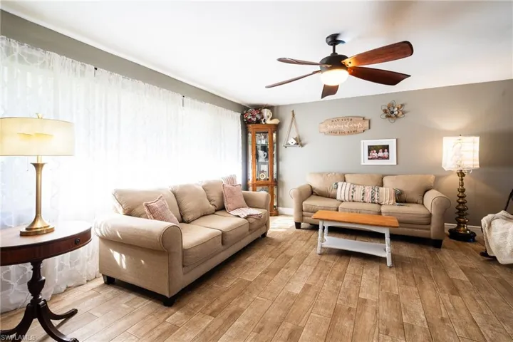Living room featuring light hardwood / wood-style floors and ceiling fan