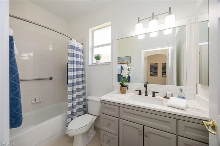 updated ceiling fan with light and tile flooring