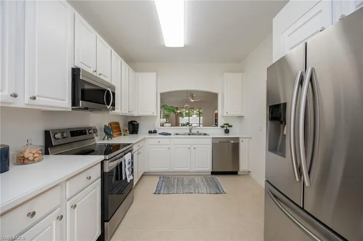 Primary bedroom w/new ceiling fan, large walk in closet and tile flooring