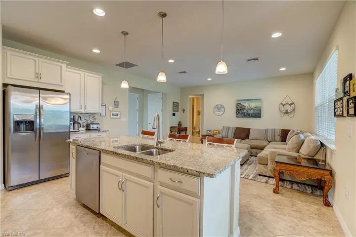 Looking towards bedrooms 2 & 3, with the dining area and sliders to lanai on the right