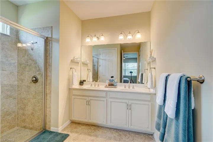 En suite with tiled shower and natural light