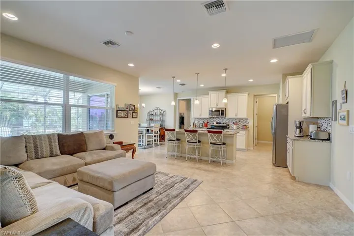 Split floor plan for privacy. Looking from bedrooms 2 & 3 towards the owner's suite. Diagonal tile throughout living spaces.