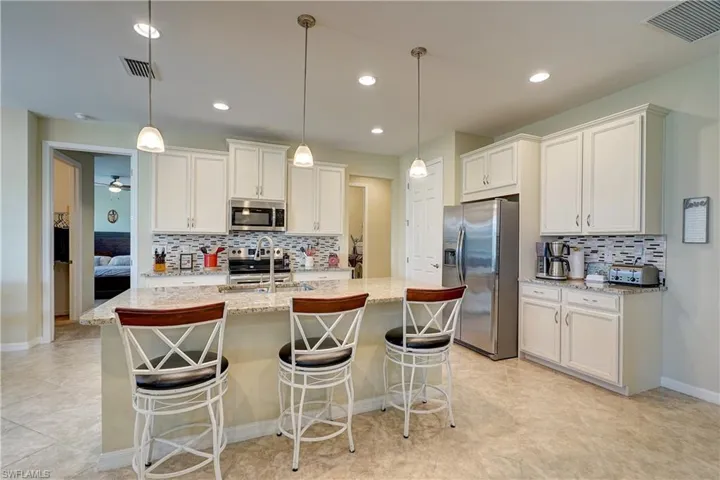 The large island with pendant lighting is a great spot to chat to friends or family while in the kitchen