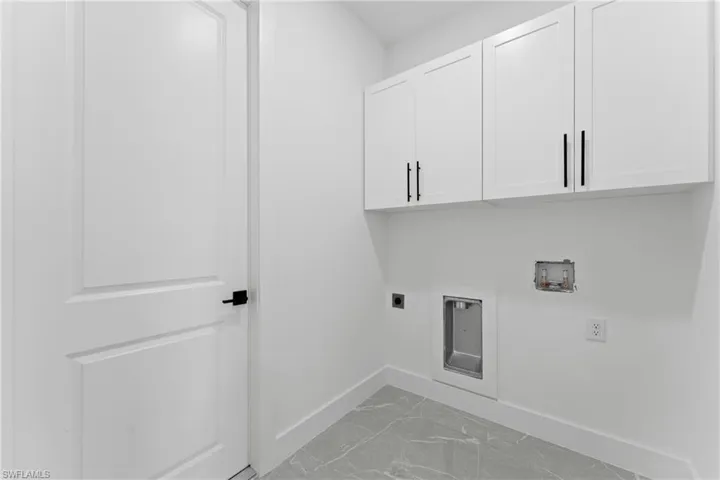 Laundry area featuring electric dryer hookup, cabinets, and hookup for a washing machine