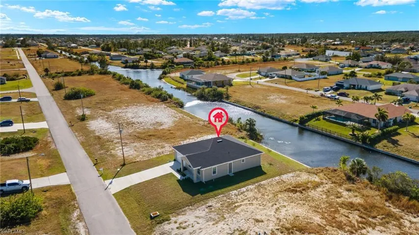 Aerial view of residential area featuring a large body of water