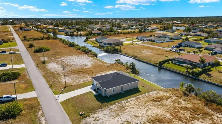 Aerial perspective of suburban area with a nearby body of water