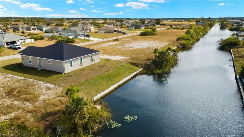 Aerial perspective of suburban area with a nearby body of water