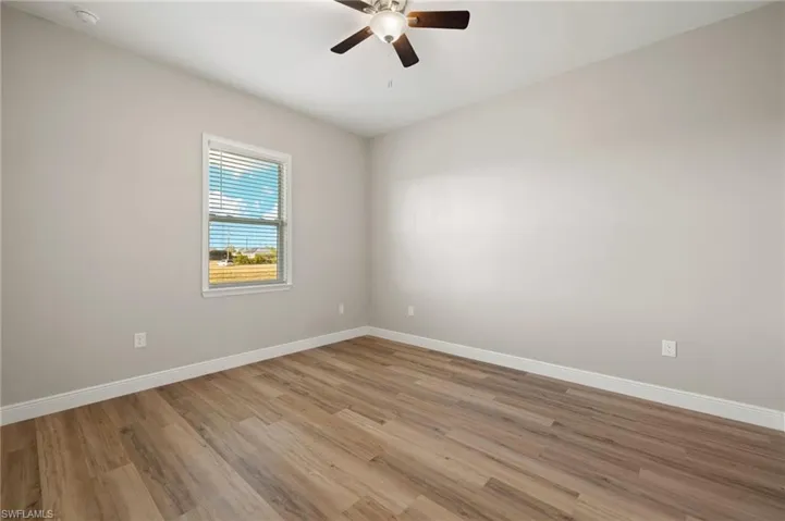 Unfurnished room with light wood finished floors and ceiling fan