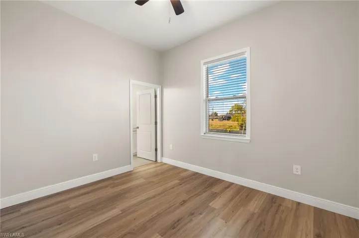 Unfurnished room with wood finished floors and ceiling fan