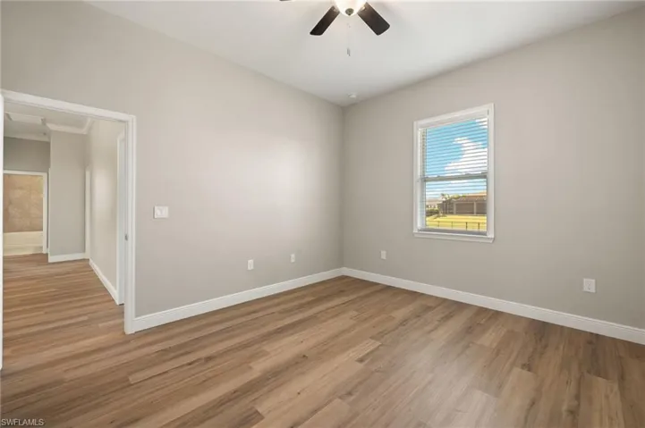 Empty room with light wood finished floors and ceiling fan