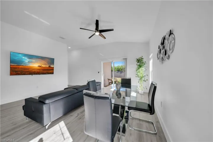 Dining room featuring ceiling fan, lofted ceiling, and light wood finished floors