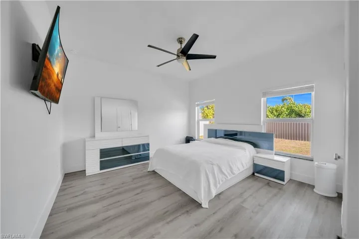 Bedroom with ceiling fan and light wood-type flooring