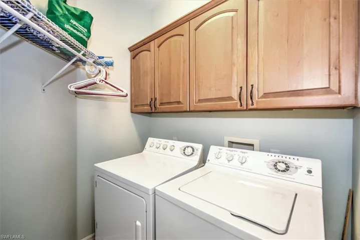 Utility room w/washer and dryer and cabinet storage!