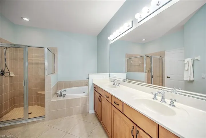 Tiled master bathroom w/dual sinks, jetted soaking tub, glass enclosed shower & separate toilet area!