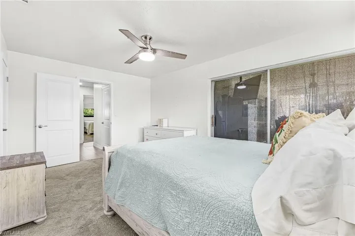 Primary bedroom with water view and sliders to the lanai